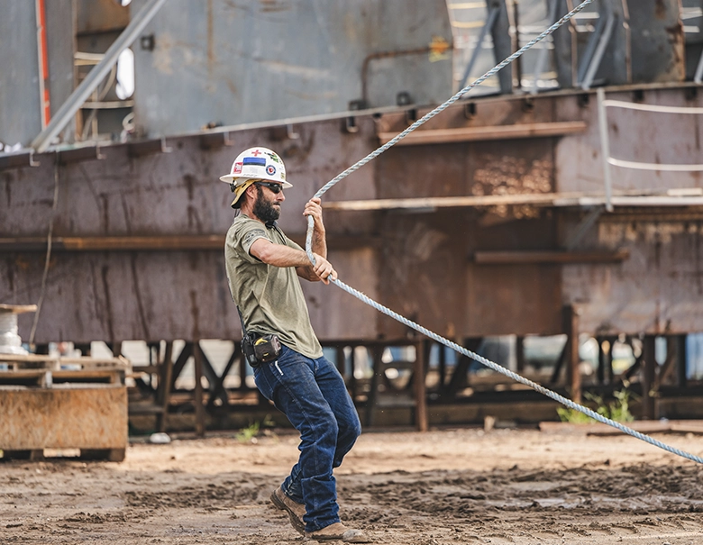 man working with rope