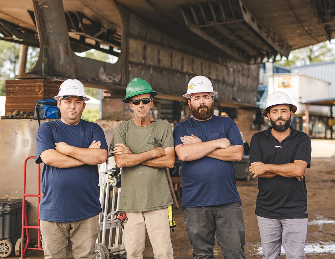 men standing in row with arms crossed